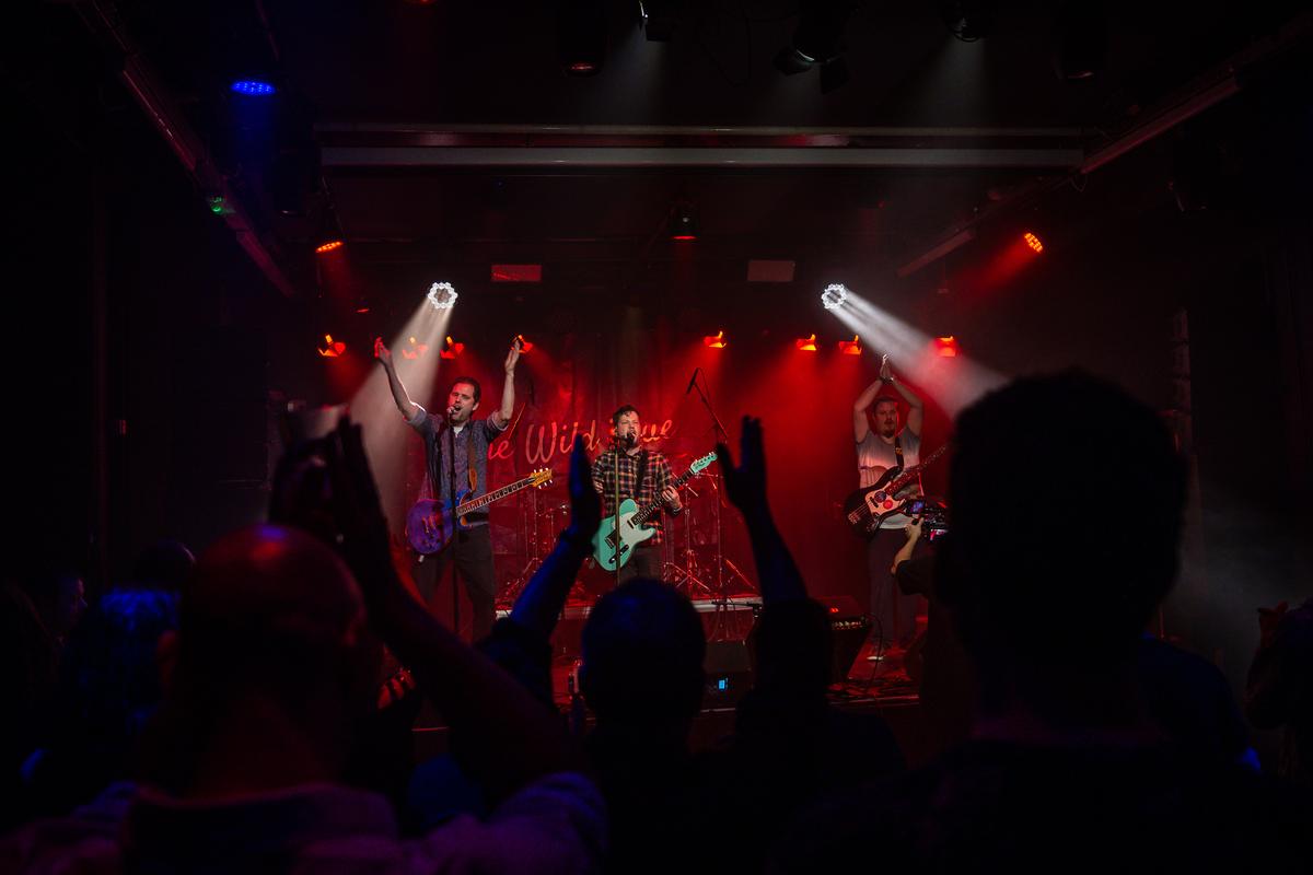 Crowd with raised hands in front of the stage