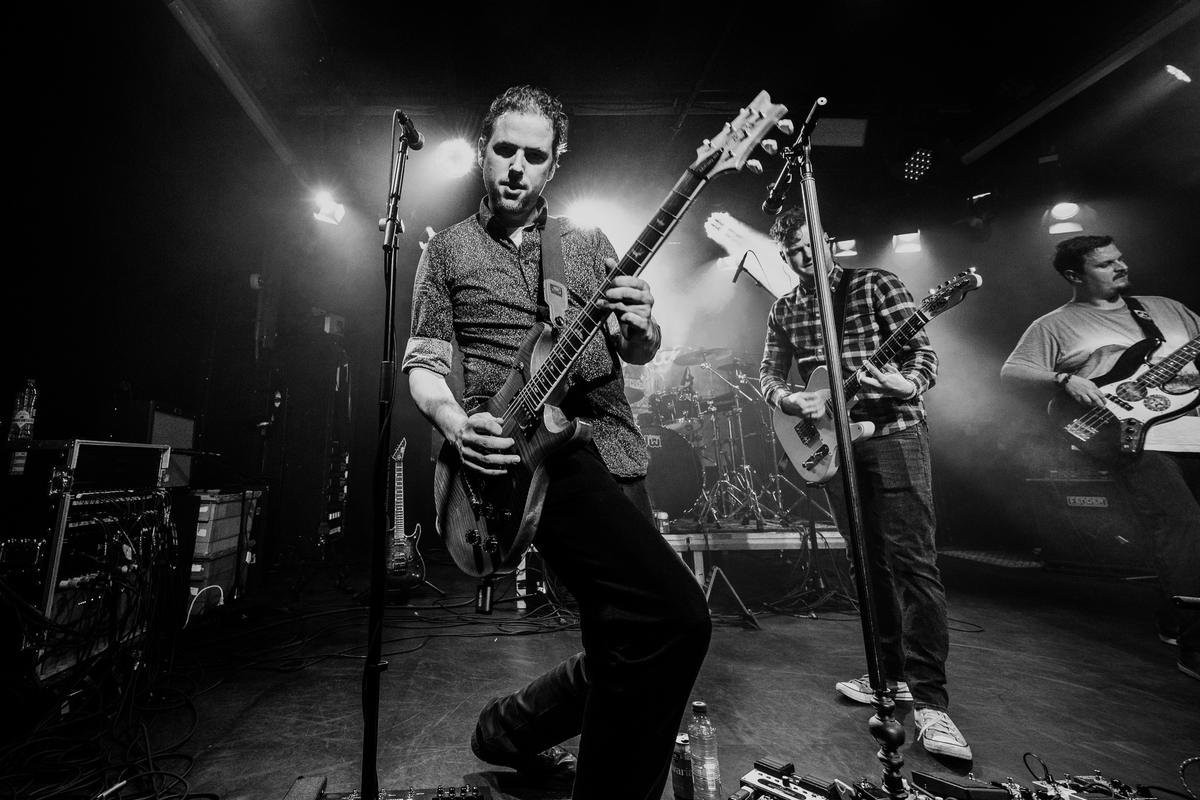Band on stage in black and white